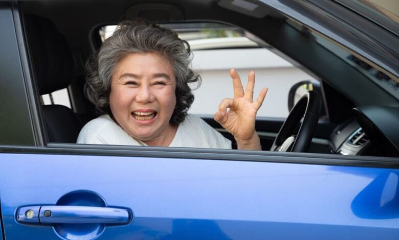 aunty show okay sign while smiling in car