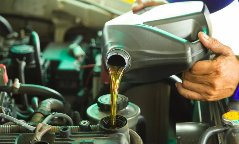 jenis minyak hitam, person pouring new engine oil into engine